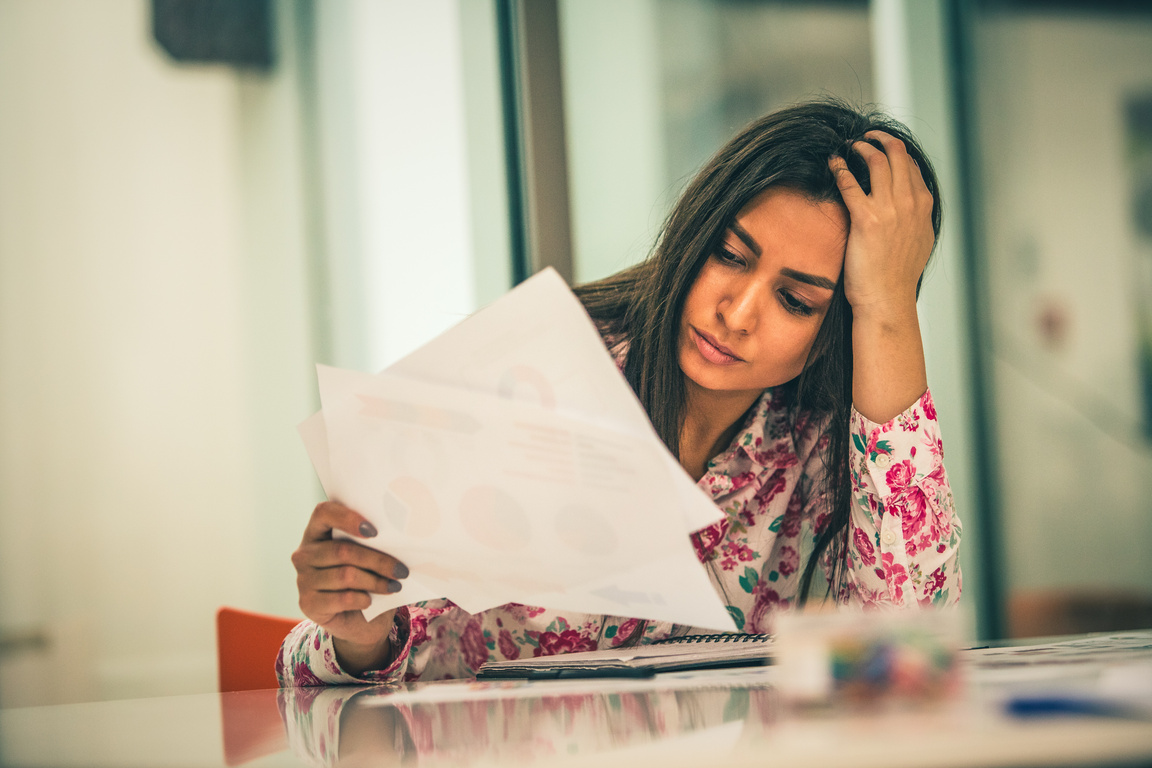 Stressed Woman Holding Documents  